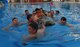 Members of the 39th Civil Engineer Squadron Explosive Ordnance Disposal team swim with their boat to shore after capsizing during the 2nd Annual Cardboard Cup Race July 10, 2015, at Incirlik Air Base, Turkey. Units from across the base designed, built and raced boats made from cardboard and duct tape. (U.S. Air Force photo by Senior Airman Michael Battles/Released)