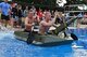 Capt. Joseph McNamara, 39th Air Base Wing Command Post chief, and Staff Sgt. Joshua Long, 39th ABW Command Post emergency controller, race across the base pool during the 2nd Annual Cardboard Cup Race July 10, 2015, at Incirlik Air Base, Turkey. Teams had the option to construct a two or four-person boat for the competition. (U.S. Air Force photo by Senior Airman Michael Battles/Released)