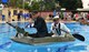 Two Airmen from Team Incirlik paddle across the base pool during the 2nd Annual Cardboard Cup Race July 10, 2015, at Incirlik Air Base, Turkey. Units from across the base designed, built and raced boats made from cardboard and duct tape. (U.S. Air Force photo by Senior Airman Michael Battles/Released)