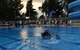 Participants of the 2nd Annual Cardboard Cup Race paddle across the base pool July 10, 2015, at Incirlik Air Base, Turkey. Each team constructed their boats out of cardboard and duct tape. (U.S. Air Force photo by Senior Airman Michael Battles/Released)