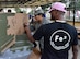 Maj. Eusebia Rios, 39th Air Base Wing deputy chaplain, decorates the FE2 cardboard boat during the 2nd Annual Cardboard Cup Race July 10, 2015, at Incirlik Air Base, Turkey. Units from across the base designed, built and raced boats made from cardboard and duct tape. (U.S. Air Force photo by Senior Airman Michael Battles/Released)