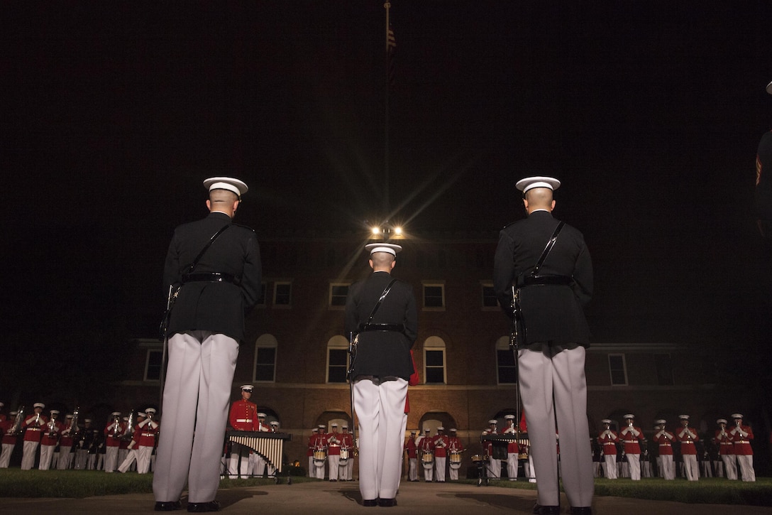 The parade staff stands at ceremonial at ease during a U.S. Marine Drum and Bugle Corps performance at an Evening Parade in Washington, D.C., July 10, 2015. U.S. Marine Corps Gen. Joseph Dunford Jr., commandant of the Marine Corps, was the hosting official for the July 10 evening parade, and the Guest of Honor were eight congressional Marines, to include Sen. Charles Roberts, Sen. Daniel Sullivan, Rep. John Kline, Rep. Michael Coffman, Rep. Scott Rigell, Rep. Paul Cook, Rep. Mike Bost and Rep. Ruben Gallego (U.S. Marine Corps Photo by Lance Cpl. Alejandro Sierras/ Released)

