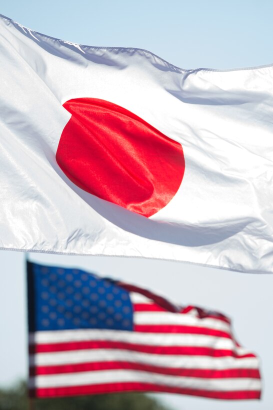 The U.S. and Japanese flags fly together as U.S. Army Gen. Martin E. Dempsey, chairman of the Joint Chiefs of staff, greets Japanese Adm. Katsutoshi Kawano, chief of the joint staff for Japan Self-Defense Forces, before a Defense Chiefs Strategy Dialogue on Fort McNair in Washington, July 16, 2015.