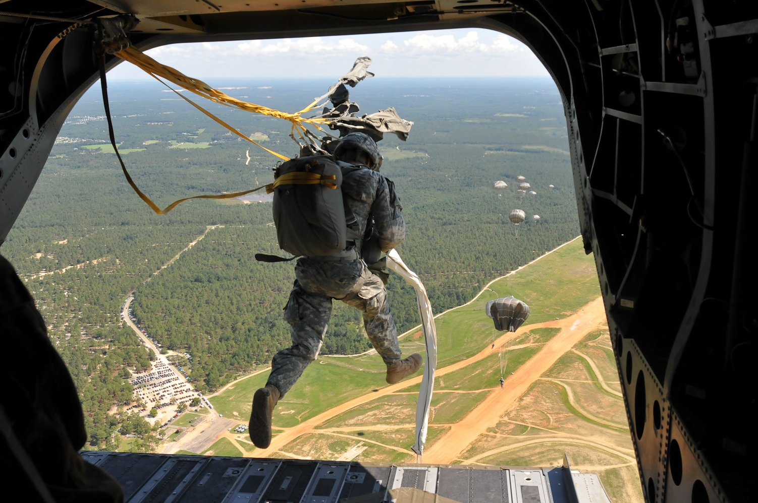 A U.S. paratrooper jumps from a CH47 Chinook helicopter during