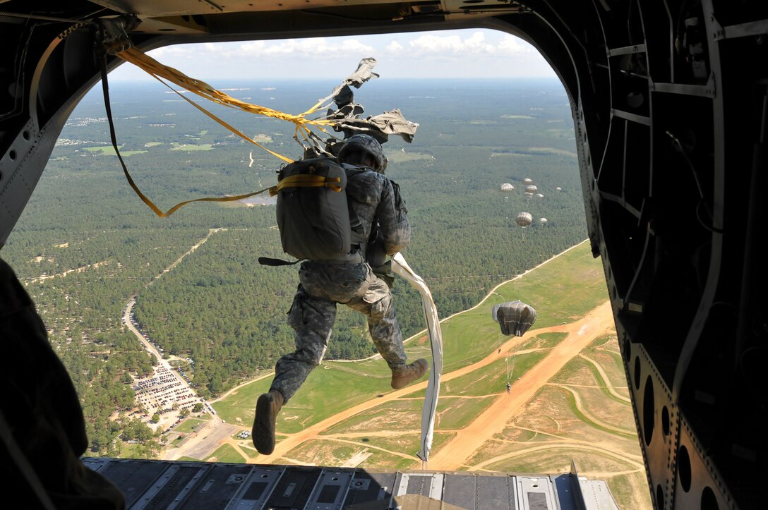 A U.S. paratrooper jumps from a CH-47 Chinook helicopter during Operation Federal Eagle, a joint airborne operation over Fort Bragg, N.C., July 15, 2015. The U.S. paratrooper is assigned to the 82nd Airborne Division's 1st Brigade Combat Team. 