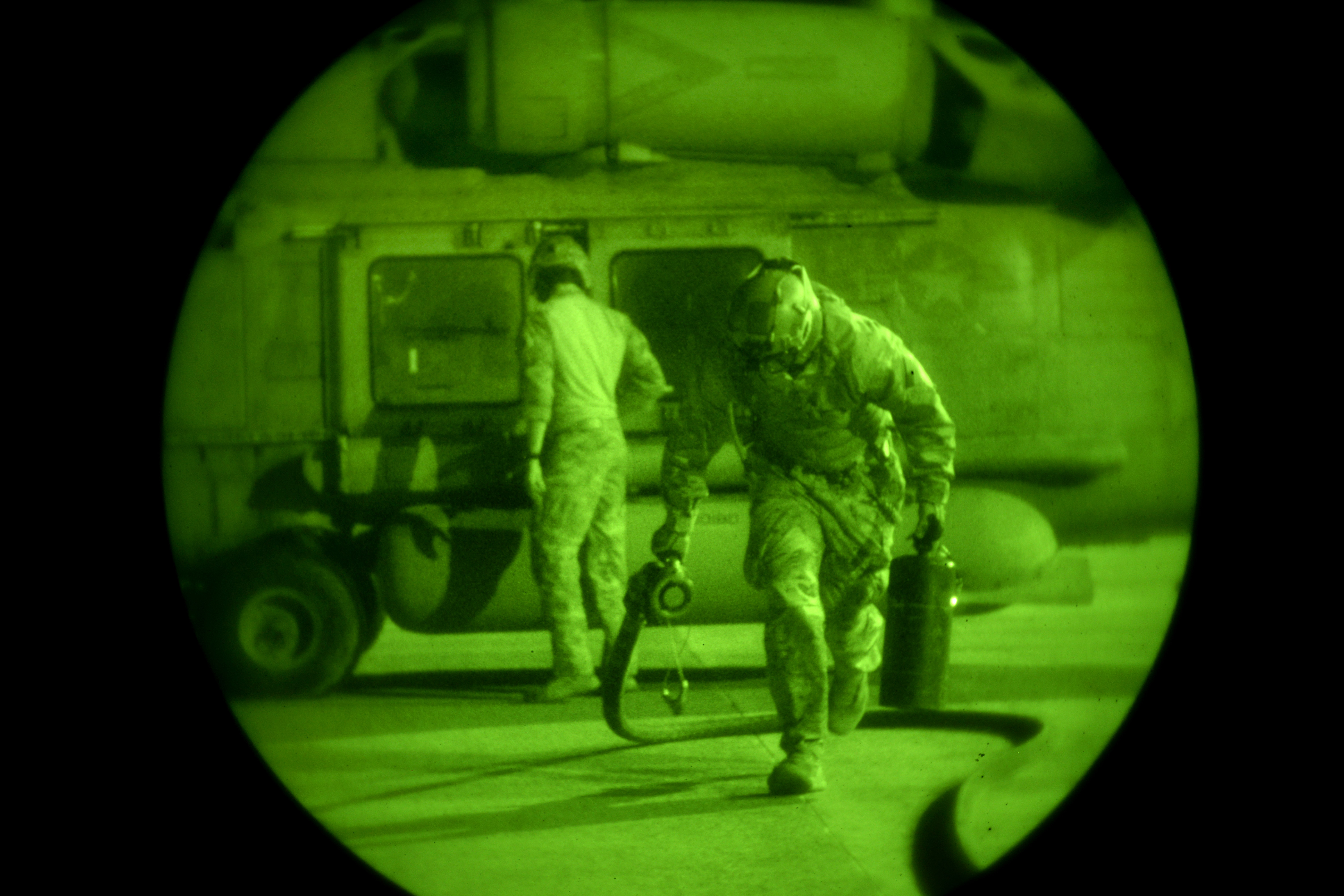 As seen through a nightvision device, U.S. airmen conduct a forward