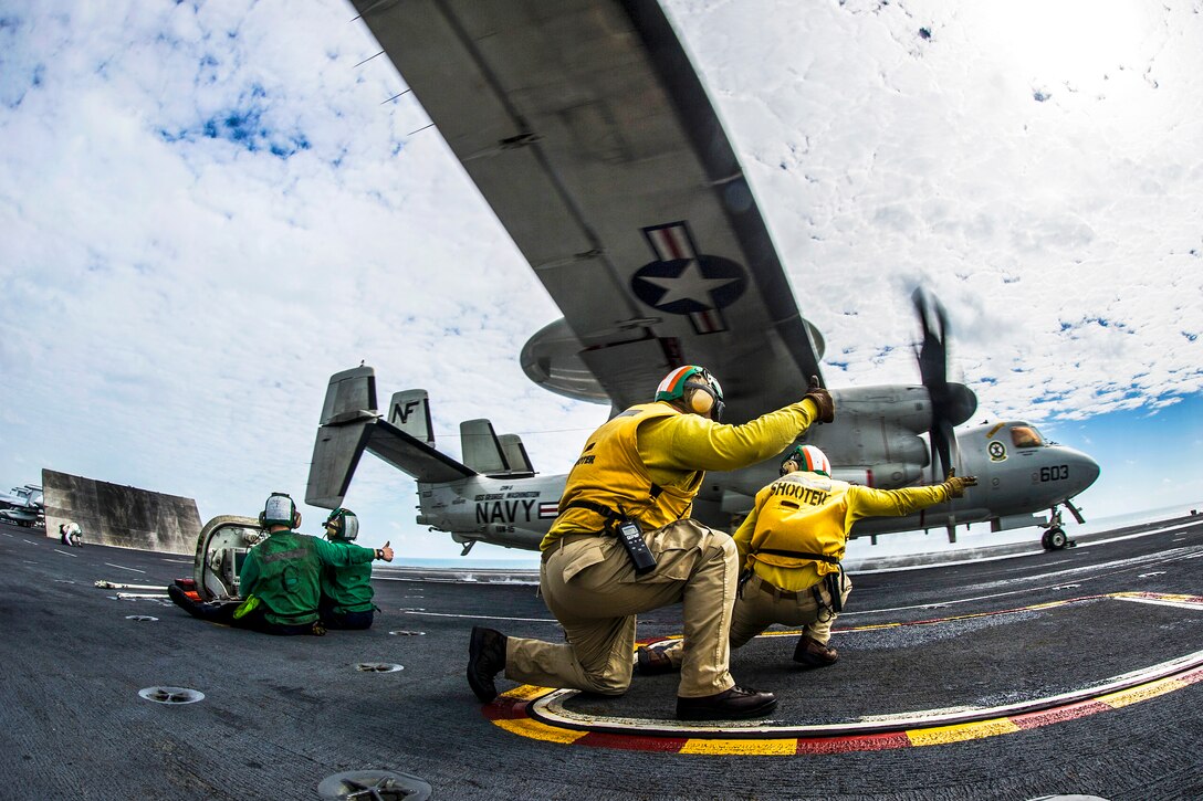 U.S. Navy Lts. Zachary Holbus, foreground, and Keith Ferrell launch an E-2C Hawkeye aircraft from the flight deck of the USS George Washington during Talisman Sabre 2015 in the Timor Sea, July 10, 2015. The bilateral exercise demonstrates the strong Australian-U.S. alliance and military relationship. The Hawkeye is assigned to  Airborne Early Warning Squadron 115.