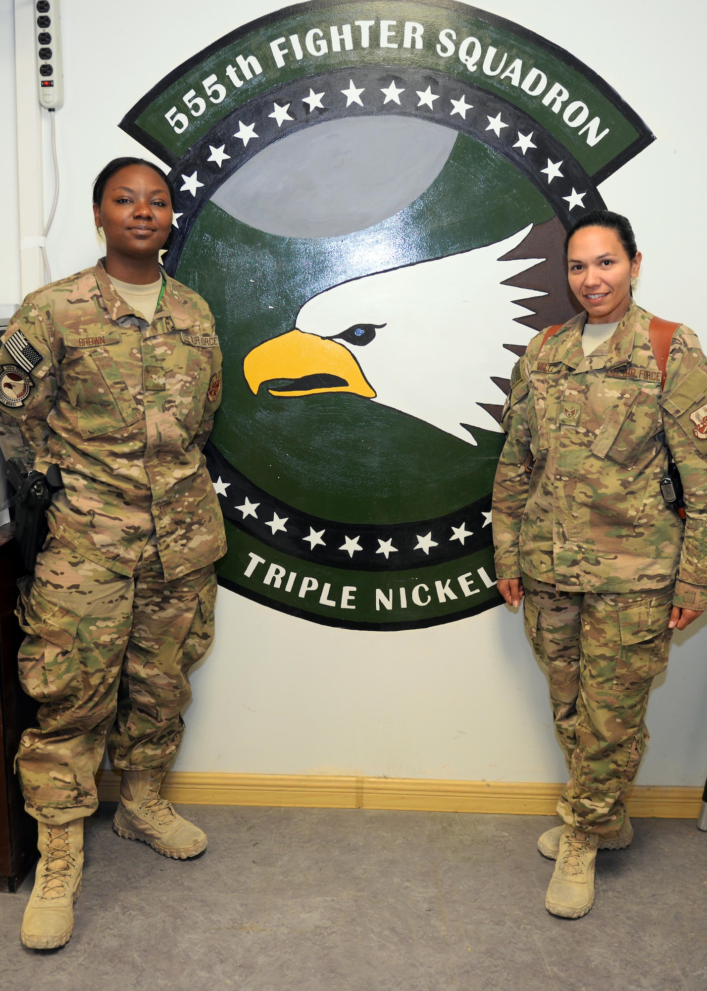 U.S. Air Force Staff Sgt. Elizabeth Velez, right, and Airman 1st Class Bryana Brown, 555th Expeditionary Fighter Squadron aviation resource managers, pose for a photo July 15, 2015, at Bagram Airfield, Afghanistan. The Airmen are both a part of the Squadron Aviation Resource Management team which is responsible for managing F-16 pilots flying currencies as well as maintaining communication between the pilots and the operations and maintenance squadrons. (U.S. Air Force photo by Senior Airman Cierra Presentado/Released)