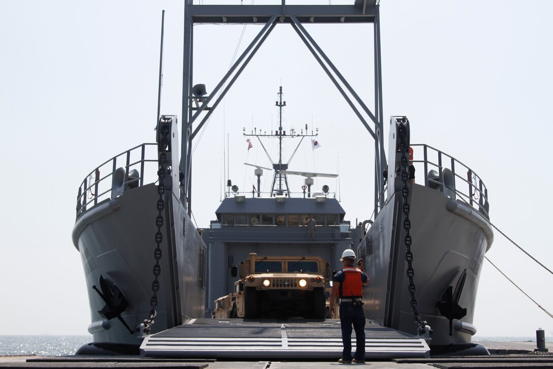 The ramp on the Landing Craft Utility 2000 is lowered and unloading of vehicles begins at Anmyeon Beach on the west coast of the Republic of Korea. CJLOTS 2015 is an exercise designed to train U.S. and ROK service members to accomplish vital logistical measures in a strategic area while strengthening communication and cooperation in the U.S. - ROK Alliance. (U.S. Army photo by Sgt. Thanh Pham)
