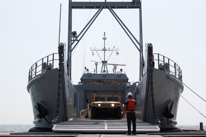 The ramp on the Landing Craft Utility 2000 is lowered and unloading of vehicles begins at Anmyeon Beach on the west coast of the Republic of Korea. CJLOTS 2015 is an exercise designed to train U.S. and ROK service members to accomplish vital logistical measures in a strategic area while strengthening communication and cooperation in the U.S. - ROK Alliance. (U.S. Army photo by Sgt. Thanh Pham)