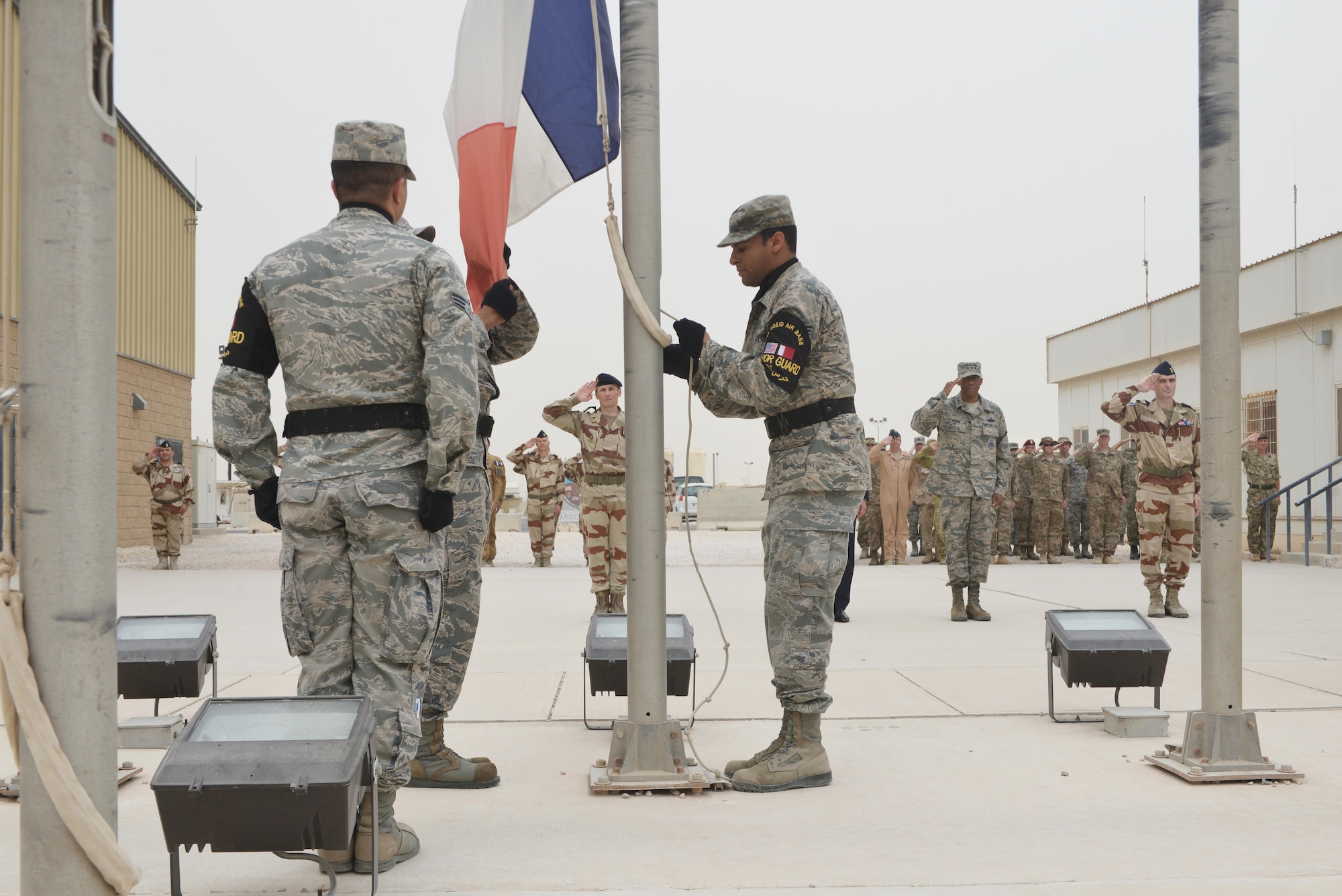 Members from the 379h Air Expeditionary Wing base honor guard prepare to raise the French national flag to begin the Bastille Day ceremony July 14, 2015 at Al Udeid Air Base, Qatar. The French celebrate July 14th as Bastille Day to commemorate the storming of Bastille at the beginning of the French revolution in 1789. (U.S. Air Force photo/Staff Sgt. Alexandre Montes)