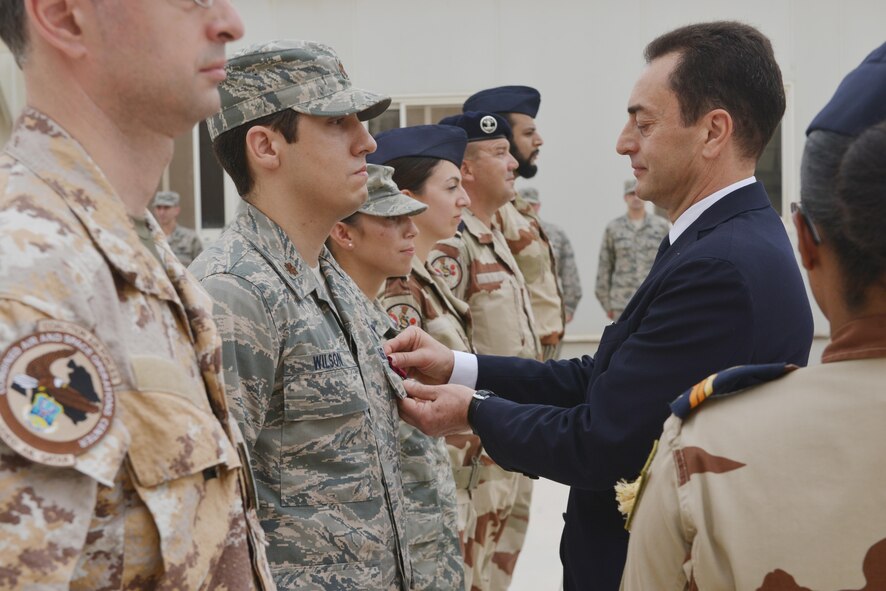 Monsieur Chevallier, Ambassador de France au Qatar, pins a French National Defense Medal onto U.S. Air Force Major Wilson, Combined Air Operation Center, during the Bastille Day ceremony July 14, 2015 at Al Udeid Air Base, Qatar. (U.S. Air Force photo/Staff Sgt. Alexandre Montes) 