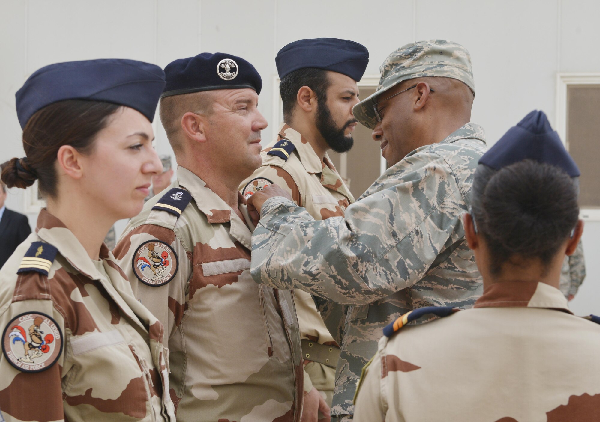 Lt. Gen Charles Brown, U.S. Air Force Central Command commander, pins a French National Defense Medal onto French Air Force members from the Combined Air Operations Center during the Bastille Day ceremony July 14, 2015 at Al Udeid Air Base, Qatar.  The French national defense medal is given to members who’ve participated in operational activities during time of war. (U.S. Air Force photo/Staff Sgt. Alexandre Montes)