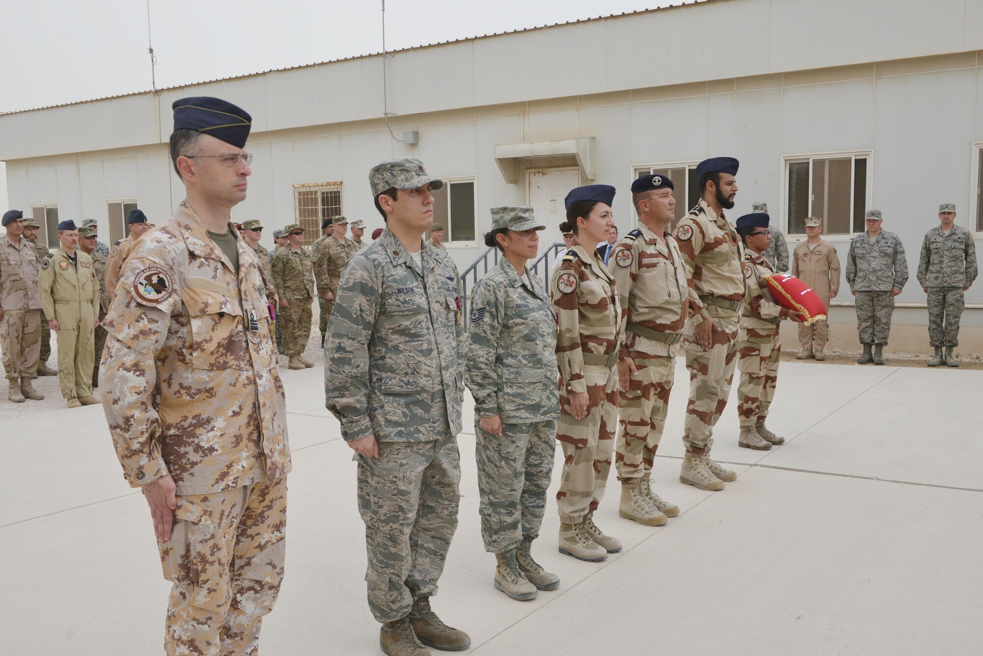 Recipients of the French National Defense Medal stand at attention during the Bastille Day ceremony July 14, 2015 at Al Udeid Air Base, Qatar.  The French National Defense Medal is given to members who’ve participated in operational activities during time of war. (U.S. Air Force photo/Staff Sgt. Alexandre Montes)