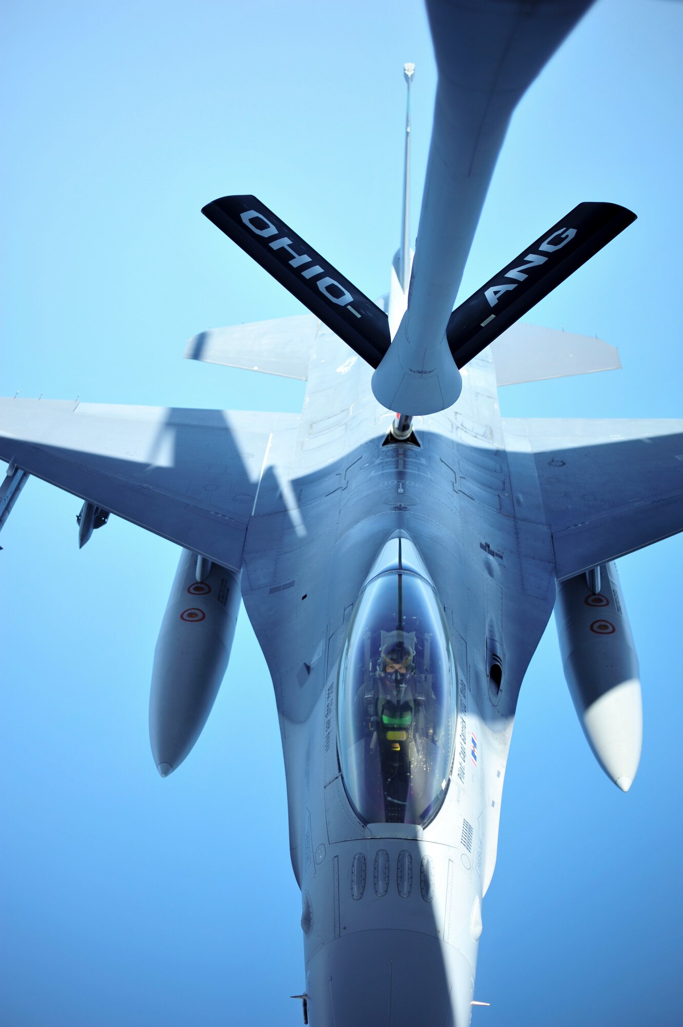 Spouses of military members at the 180th Fighter Wing were given the rare opportunity to take a ride on a KC-135 Stratotanker and watch F-16 Fighting Falcons being refueled mid-air on July 12, 2015, in Swanton, Ohio. The “Spouse Lift” included wives of the pilots flying the F-16s. From the refueling pod on the underside of the tanker, spouses watched as the F-16s approached, close enough to wave “hello,” the lower side of the tanker’s tail to receive fuel. The spouses were also given the chance to talk to the fighter pilots with headsets from the refueling pod. Military members depend on their husbands and wives for support that is critical to the success of the mission. The “Spouse Lift” was a fantastic chance for 180th Airmen to give a little something back.