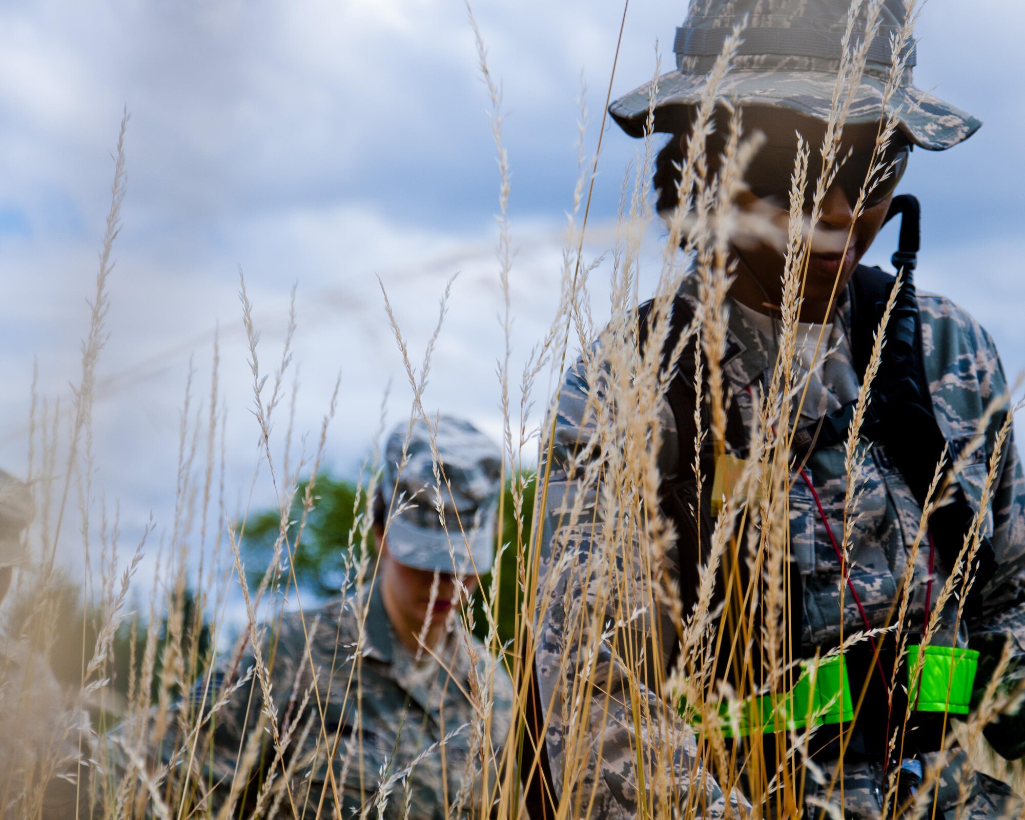 Medics from the 446th Aeromedical Staging Squadron make their way through the woods for the Care Under Fire exercise at Joint Base Lewis-McChord, July 12, 2015. The Care Under Fire exercise was designed locally by the 446th ASTS in order to simulate combat conditions and establish team oriented training scenarios. Medics were offered land navigation training in order to enhance their combat readiness in austere locations. (U.S. Air Force photo by Senior Airman Daniel Liddicoet/Released)