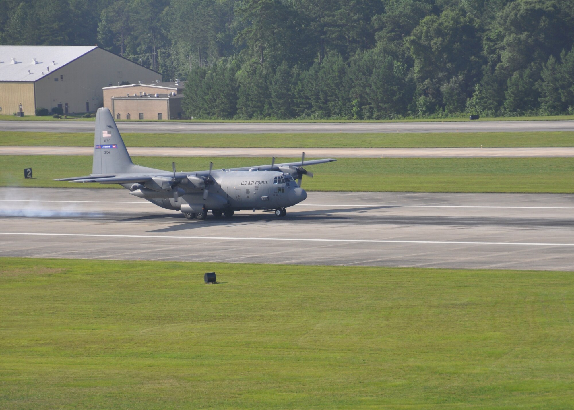 A C-130 Hercules takes off from the runway at Dobbins Air Reserve Base, Ga., July 11, 2015. Col. Brett Clark, 94th Airlift Wing commander, retired the same afternoon and flew for the last time with his son on board. (US Air Force Photo/ Senior Airman Miles Wilson)