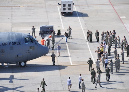 Col. Brett Clark, 94th Airlift Wing commander, is sprayed with water on the flight line at Dobbins Air Reserve Base, Ga., July 11, 2015. Clark flew for the last time before he retired from the United States Air Force after 32 years, and was greeted by friends and family with tanks and coolers of water to soak him with. (US Air Force Photo/ Senior Airman Miles Wilson)