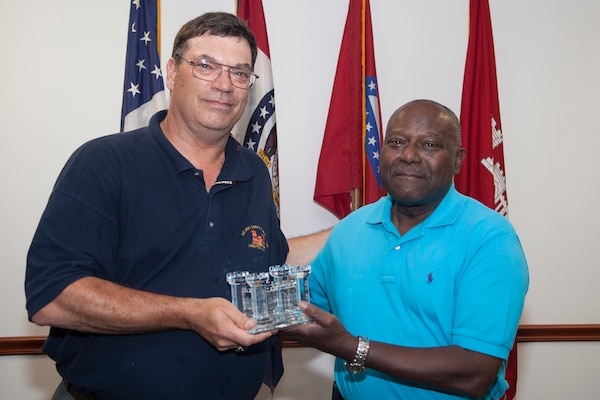 Dean Erickson, Little Rock District’s Chief of Logistics, presents a crystal Corps Castle to Henry Hollins in appreciation for his service and dedication to duty.  Hollins served as the District’s facility manager for more than 20 years.