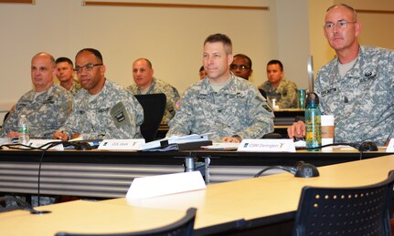 The 80th Training Command (TASS) command team, along with former 800th Logistics Support Brigade commander Col. Howard C.W. Geck, listen as two 800th LSB Soldiers explain the benefits of participation in the 80th TC Best Warrior Competition and the Sergeant Audie Murphy Club induction boards. The briefing took place during the brigade’s Yearly Training Brief in Mustang, Okla., June 27, 2015. From left to right, Brig. Gen. Thomas Evans, 80th TC Deputy Commander- Support, Maj. Gen. A.C. Roper, commander 80th TC, Geck and Command Sgt. Maj. Jeffrey Darlington, 80th TC command sergeant major.