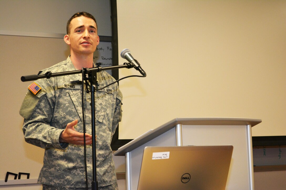 Spc. Charles Reding, the 80th Training Command 2015 Best Warrior Competition runner-up in the lower enlisted category, briefs the 80th’s command team as well as leaders from across the 800th Logistics Support Brigade during the brigade’s Yearly Training Brief in Mustang, Okla., June 27, 2015. Reding conducted the briefing on the benefits of Soldier participation in the BWC.