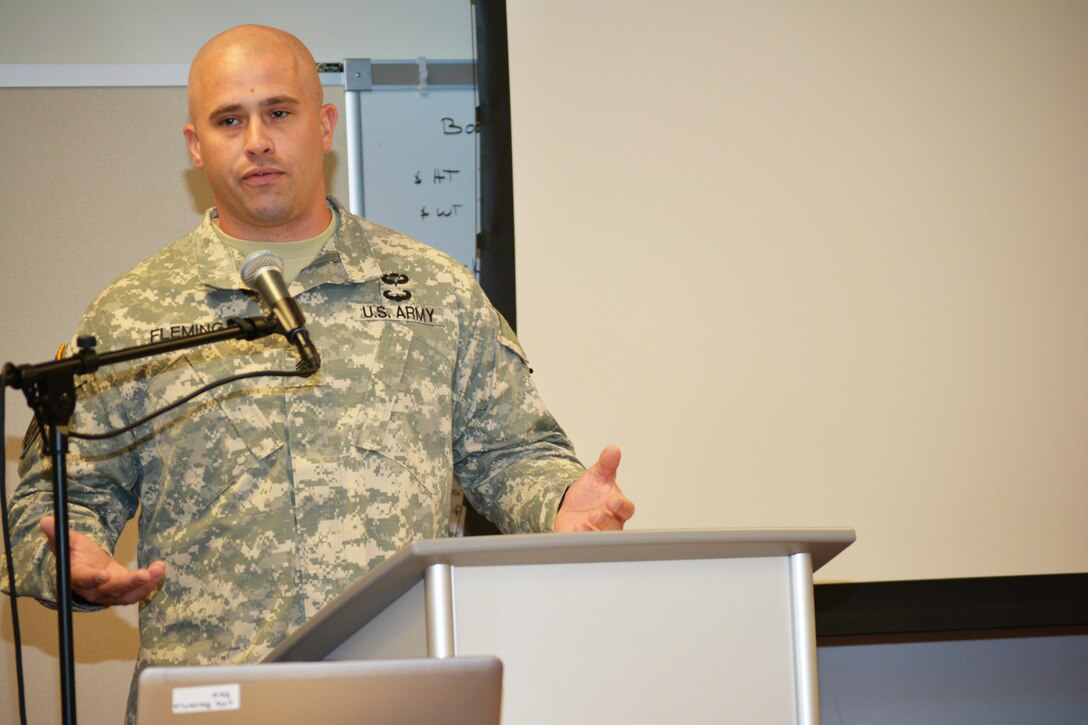 Staff Sgt. William Fleming, a Sergeant Audie Murphy Club inductee and 80th Training Command 2015 Best Warrior Competition participant briefs the 80th’s command team as well as leaders from across the 800th Logistics Support Brigade on the benefits of Soldier participation in the Best Warrior Competition and the Sergeant Audie Murphy Club induction boards. Fleming conducted the briefing during the brigade’s Yearly Training Brief in Mustang, Okla., June 27, 2015.