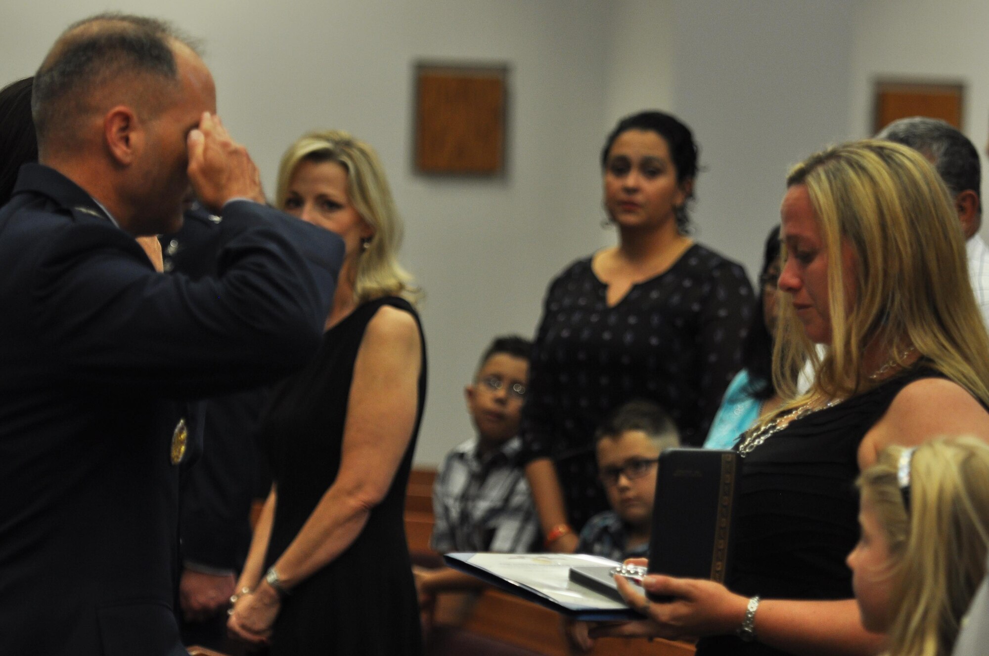 U.S. Air Force Col. Michael L. Downs, 17th Training Wing Commander, presents Michele Kelley with the Meritorious Service Medal posthumously awarded to her husband for Tech. Sgt. Christopher Kelley, 17th Security Forces Squadron individual mobilization augmentee, during a Memorial Service in his honor at the Taylor Chapel on Goodfellow Air Force Base, Texas, July 16, 2015. The medal honors the memory and service of Kelley and symbolizes the respect the military has for members and their families who have paid the ultimate sacrifice for their country. (U.S. Air Force photo by Senior Airman Joshua Edwards/Released)