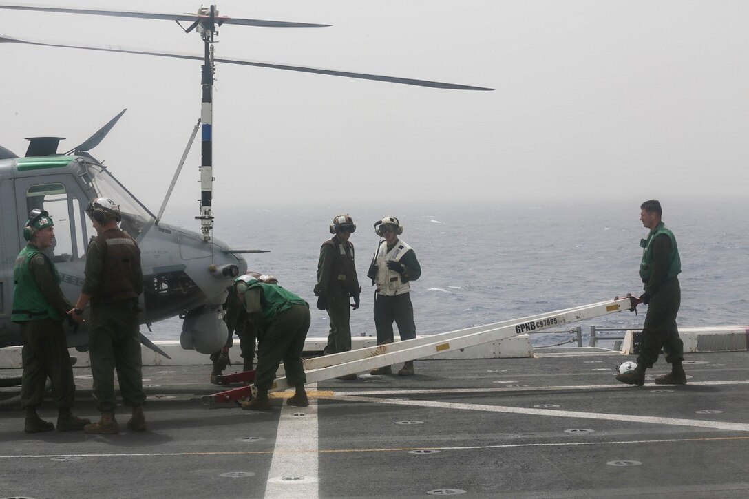 ARABIAN SEA (June 23, 2015)  U.S. Marines and Sailors prepare a UH-1Y Venom with the “Greyhawks” of Marine Medium Tiltrotor Squadron 161 (Reinforced) for transport on the flight deck of the amphibious transport dock ship USS Anchorage (LPD 23).  Anchorage is part of the Essex Amphibious Ready Group and, with the embarked 15th Marine Expeditionary Unit, is deployed in support of maritime security operations and theater security cooperation efforts in the U.S. 5th Fleet area of operations. (U.S. Marine Corps photo by Sgt. Jamean Berry/ Released)