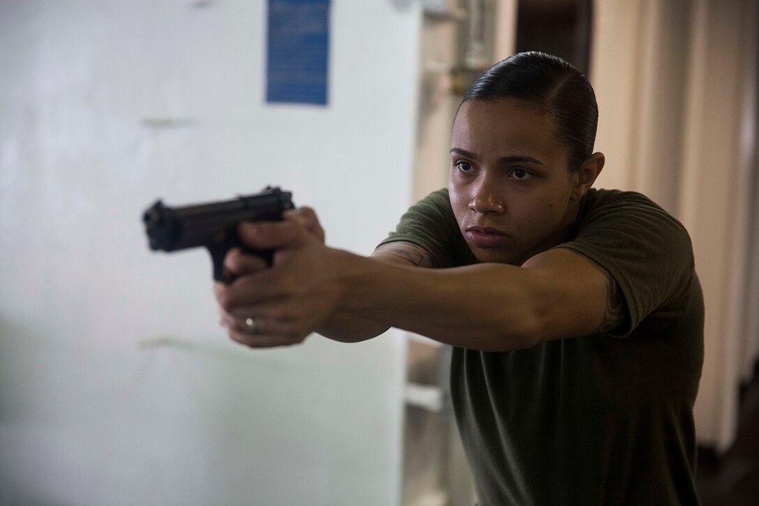 GULF OF ADEN (July 9, 2015) U.S. Marine Lance Cpl. Brianna Mikus practices dry-fire drills with an M9 Beretta pistol aboard the amphibious assault ship USS Essex (LHD 2). Mikus is a radio operator with Combat Logistics Battalion 15, 15th Marine Expeditionary Unit. Dry-fire drills help the Marines focus on the fundamentals of marksmanship. The 15th MEU is embarked on the Essex Amphibious Ready Group and deployed to maintain regional security in the U.S. 5th Fleet area of operations. (U.S. Marine Corps photo by Cpl. Anna Albrecht/Released)