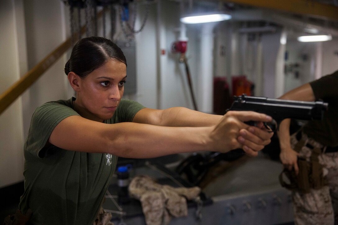 GULF OF ADEN (July 9, 2015) U.S. Marine Cpl Justine Woodend practices dry-fire drills with an M9 Beretta pistol aboard the amphibious assault ship USS Essex (LHD 2). Woodend is a motor transportation operator with Combat Logistics Battalion 15, 15th Marine Expeditionary Unit. Dry-fire drills help the Marines focus on the fundamentals of marksmanship. The 15th MEU is embarked on the Essex Amphibious Ready Group and deployed to maintain regional security in the U.S. 5th Fleet area of operations. (U.S. Marine Corps photo by Cpl. Anna Albrecht/Released)