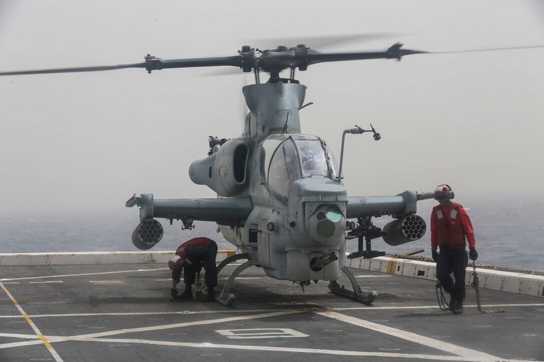 ARABIAN SEA (July 14, 2015) U.S. Navy Sailors unhook chains from an AH-1Z Viper with the “Greyhawks” of Marine Medium Tiltrotor Squadron 161 (Reinforced), 15th Marine Expeditionary Unit, on the flight deck of the amphibious transport dock ship USS Anchorage (LPD 23).  The “Greyhawks” are the aviation combat element of the 15th MEU, and embarked aboard the ships of the Essex Amphibious Ready Group, are deployed in support of maritime security operations and theater security cooperation efforts in the U.S. 5th Fleet area of operations. (U.S. Marine Corps photo by Sgt. Jamean Berry/ Released)