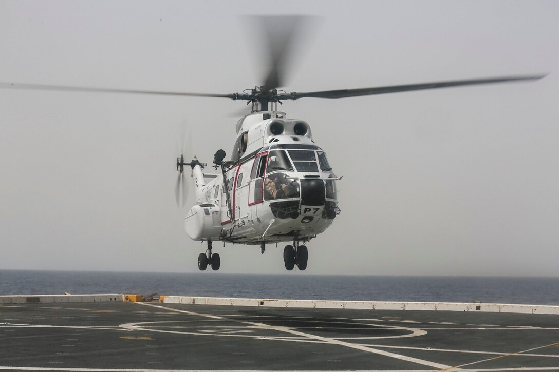 ARABIAN SEA (July 14, 2015) An AS332 Super Puma takes off from the amphibious transport dockship USS Anchorage (LPD 23) while performing a vertical replenishment with the USNS Carl Brashear (T-AKE-7). Anchorage is part of the Essex Amphibious Ready Group and, with the embarked 15th Marine Expeditionary Unit, is deployed in support of maritime security operations and theater security cooperation efforts in the U.S. 5th Fleet area of operations. (U.S. Marine Corps photo by Sgt. Jamean Berry/ Released)
