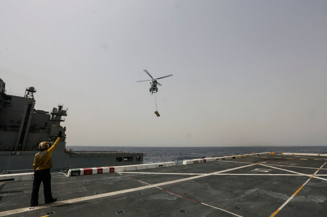 ARABIAN SEA (July 14, 2015) An AS332 Super Puma transports supplies from the USNS Carl Brashear (T-AKE-7) to the amphibious transport dockship USS Anchorage (LPD 23). Anchorage is part of the Essex Amphibious Ready Group and, with the embarked 15th Marine Expeditionary Unit, is deployed in support of maritime security operations and theater security cooperation efforts in the U.S. 5th Fleet area of operations. (U.S. Marine Corps photo by Sgt. Jamean Berry/ Released)