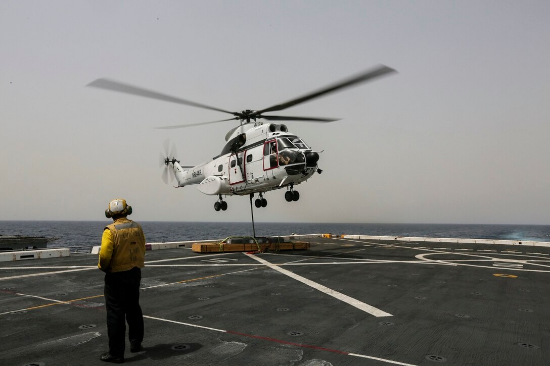 ARABIAN SEA (July 14, 2015) An AS332 Super Puma drops supplies during a vertical replenishment from the USNS Carl Brashear (T-AKE-7) to the amphibious transport dock ship USS Anchorage (LPD 23). Anchorage is part of the Essex Amphibious Ready Group and, with the embarked 15th Marine Expeditionary Unit, is deployed in support of maritime security operations and theater security cooperation efforts in the U.S. 5th Fleet area of operations. (U.S. Marine Corps photo by Sgt. Jamean Berry/ Released)