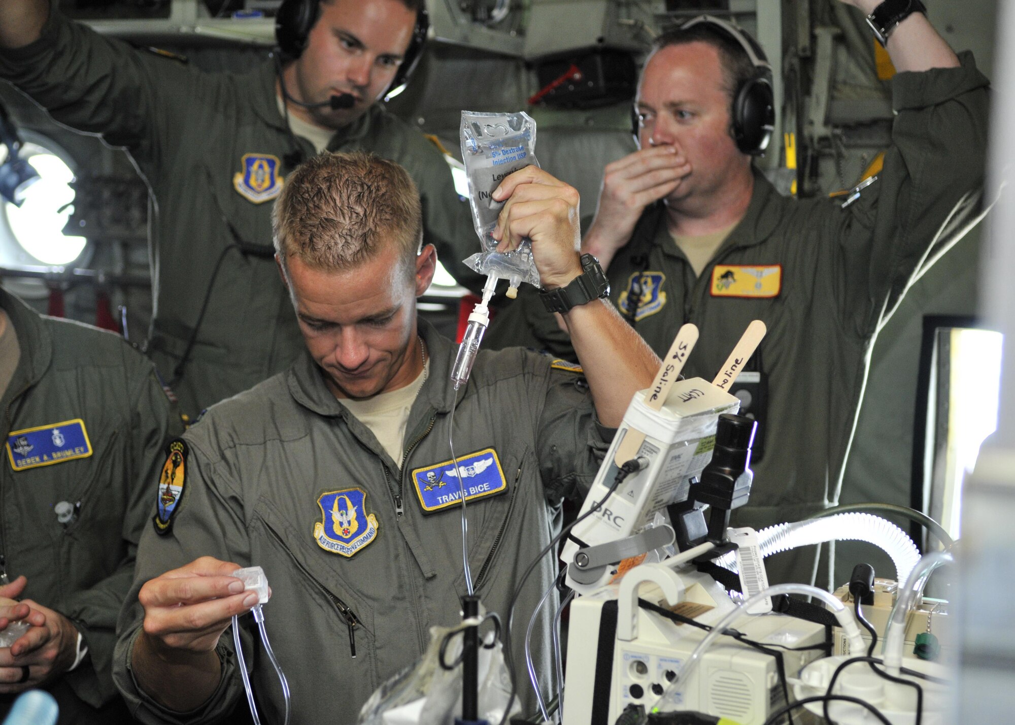 Capt. Travis Bice, 920th Rescue Wing aeromedical staging squadron critical care flight nurse, prepares an IV to treat a patient on a C-130/H rescue aircraft during MEDBEACH 2015 joint service exercise at Patrick Air Force Base, Fla., July 11, 2015. This exercise prepares military medical personnel for deployments by providing realistic scenarios that they may see during a wartime situation. (U.S. Air Force photo by Tech. Sgt. Michael Means)