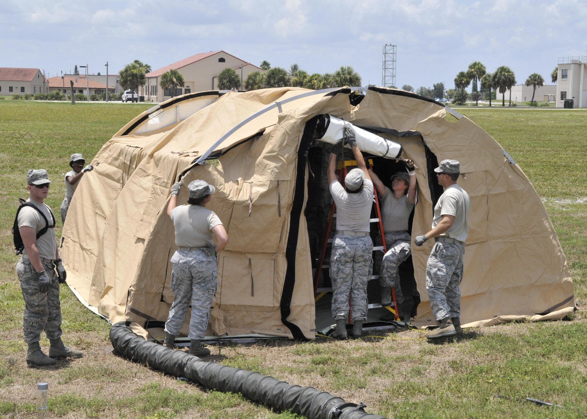 Reservists assigned to the 920th Rescue Wing Aeromedical Staging Squadron, assemble a tent to create a staging facility during MEDBEACH 2015 joint service exercise at Patrick Air Force Base, Fla., July 11, 2015. MEDBEACH 2015 is a joint-service exercise in conjunction with the Army, Navy and Nation Guard and provides realistic training while saving tax payer more than $1 million. . (U.S. Air Force photo by Tech. Sgt. Michael Means)