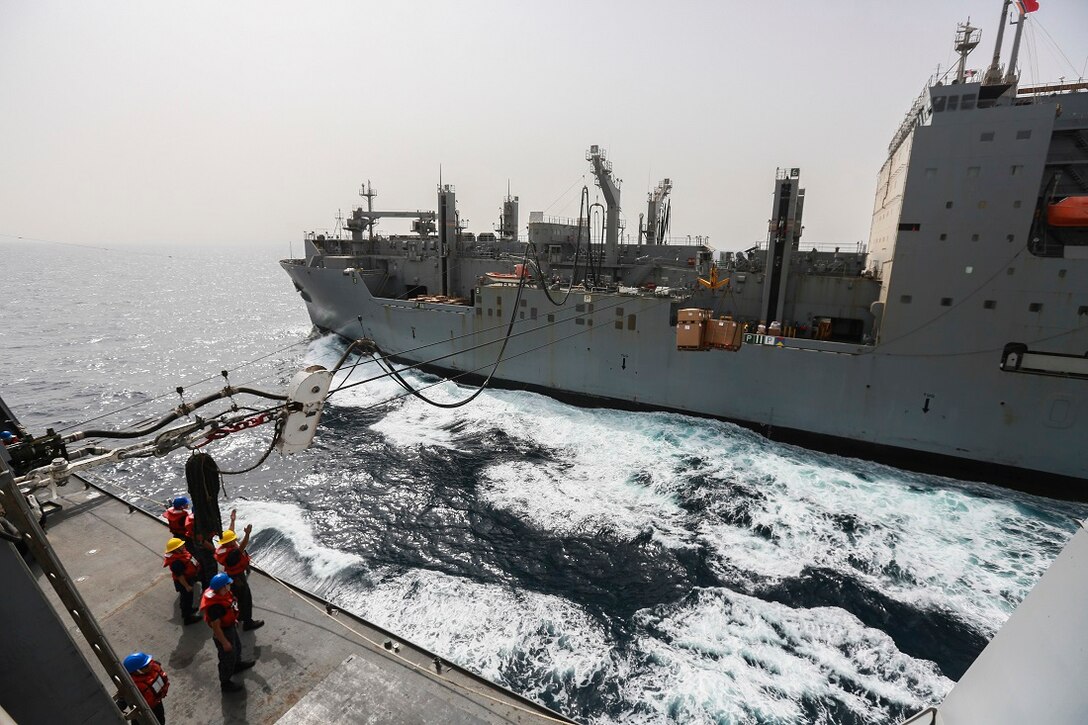The USNS Carl Brashear (T-AKE-7) delivers supplies and goods to the amphibious transport dock ship USS Anchorage (LPD 23) during a replenishment at sea. The Marines of the 15th Marine Expeditionary Unit are embarked aboard the Anchorage, which is part of the Essex Amphibious Ready Group and is deployed in support of maritime security operations and theater security cooperation efforts in the U.S. 5th Fleet area of operations. (U.S. Marine Corps photo by Sgt. Steve H. Lopez/ Released)