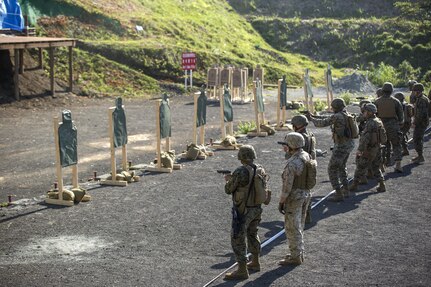 MARINE CORPS AIR STATION IWAKUNI, Japan (July 14, 2015) - Marines with Combat Logistics Company 36 (CLC-36) fire Beretta M9 9mm Pistols during Exercise Dragon Fire 2015, at Camp Fuji.  CLC-36 gave their Marines the chance to fire pistols in order to broaden their knowledge and abilities with different weapons. CLC-36 participates in the annual Dragon Fire exercise to refresh their Marine's basic riflemen skills and build camaraderie, thus preparing them for possible combat situations with their fellow Marines.  