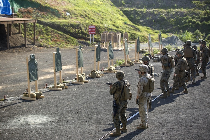 MARINE CORPS AIR STATION IWAKUNI, Japan (July 14, 2015) - Marines with Combat Logistics Company 36 (CLC-36) fire Beretta M9 9mm Pistols during Exercise Dragon Fire 2015, at Camp Fuji.  CLC-36 gave their Marines the chance to fire pistols in order to broaden their knowledge and abilities with different weapons. CLC-36 participates in the annual Dragon Fire exercise to refresh their Marine's basic riflemen skills and build camaraderie, thus preparing them for possible combat situations with their fellow Marines.  