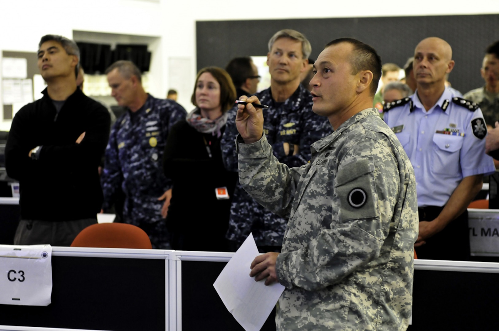 GALLIPOLI BARRACKS, Australia (July 17, 2015) - Maj. Siegfried Ramil, a battle major with I Corps, briefs Vice Adm. Robert Thomas, 7th Fleet commander, about the current operations I Corps is tracking for their command portion of Exercise Talisman Sabre 15 during a tour with other non-governmental agencies for an interagency observers day visit.   