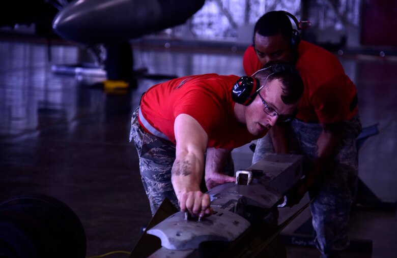 U.S. Air Force Senior Airman Kyle Faragher and Staff Sgt. Michael Barnes, 35th Aircraft Maintenance Squadron load crew members, compete in the third quarter load crew competition at Misawa Air Base, Japan, July 17, 2015. The competition evaluated the load crew team’s overall loading ability, which includes quality of work and finishing time. (U.S. Air Force photo by Airman 1st Class Jordyn Fetter/Released) 
