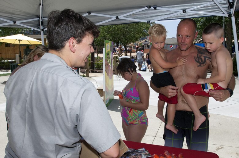 J. Percy Priest Lake Park Ranger Adam Johnson hands out water safety goodies and provides information at Nashville Shores Lakeside Resort July 10, 2015.  The Corps is setting up a booth every Friday from noon to 2 p.m. to pass out water safety goodies and to talk with families about wearing life jackets when recreating at the park and lake. 