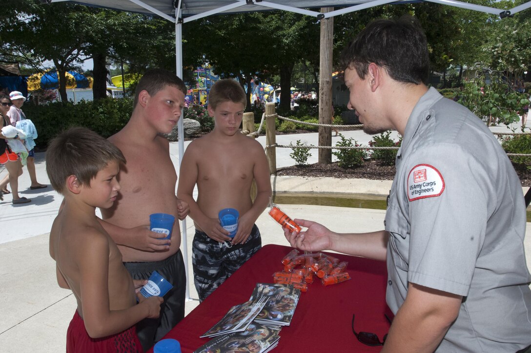 J. Percy Priest Lake Park Ranger Adam Johnson hands out water safety goodies and provides information at Nashville Shores Lakeside Resort July 10, 2015.  The Corps is setting up a booth every Friday from noon to 2 p.m. to pass out water safety goodies and to talk with families about wearing life jackets when recreating at the park and lake.