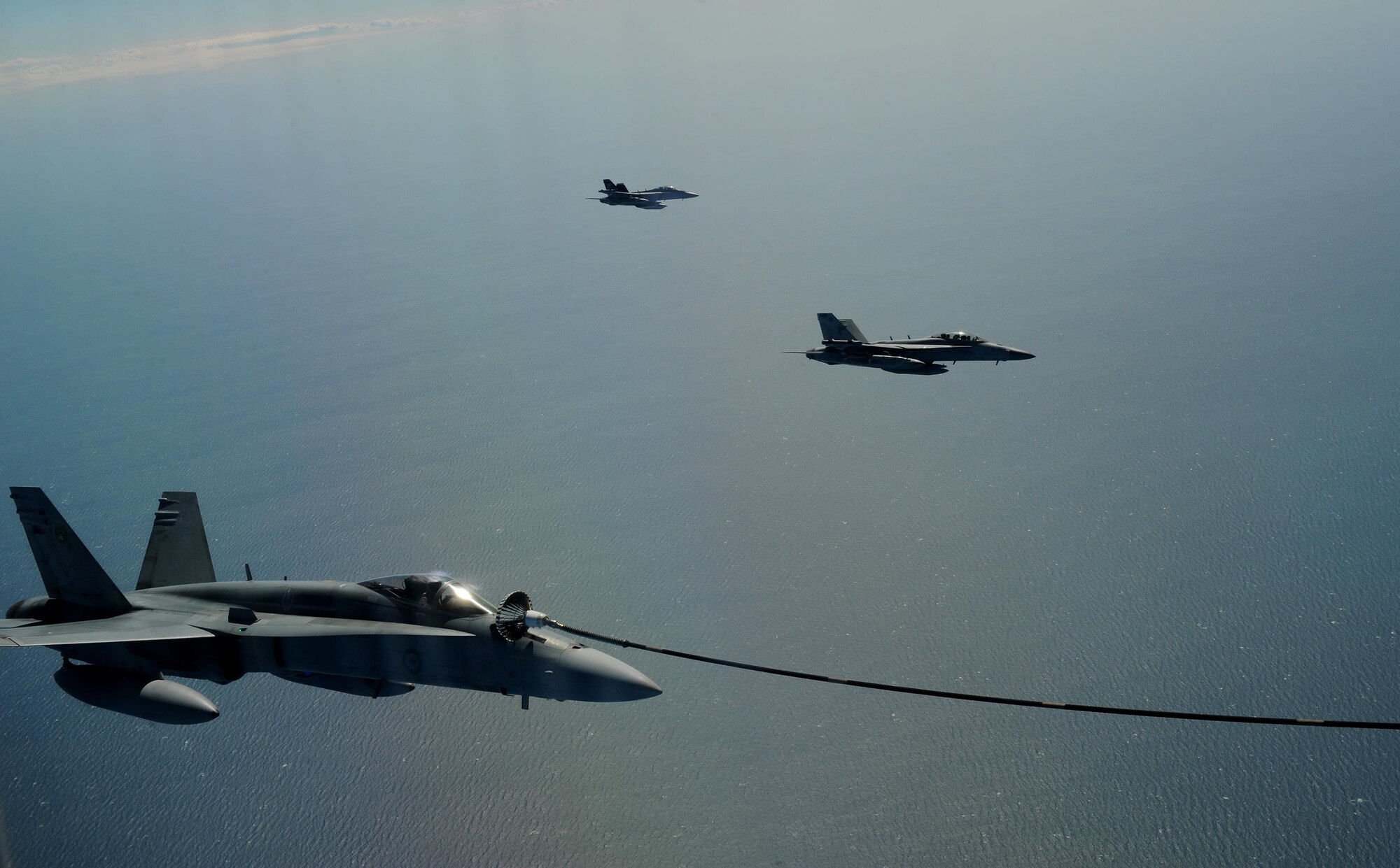 A Royal Australian Air Force KC-30A Multi Role Tanker Transport refuels a RAAF F/A-18 Hornet during a refueling training exercise as part of Talisman Sabre 2015 near Darwin, Australia, July 13, 2015. U.S. and Australian forces are conducting air refueling missions throughout the Talisman Sabre 2015 exercise to improve interoperability and familiarization with each other's procedures.Talisman Sabre is a biennial exercise that provides an invaluable opportunity for nearly 30,000 U.S. and Australian defense forces to conduct operations in a combined, joint and interagency environment that will increase both countries’ ability to plan and execute a full range of operations from combat missions to humanitarian assistance efforts. (U.S. Air Force photo by Staff Sgt. Alexander Martinez/Released)
