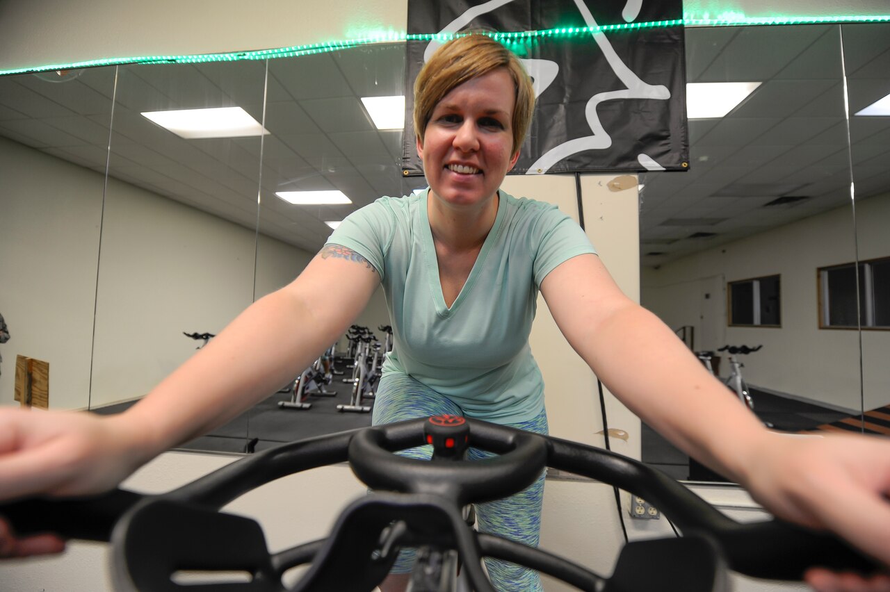 Air Force Tech. Sgt. Bethany Watson, noncommissioned officer in charge of the 18th Wing First Term Airman Center, sits on her lead stationary bicycle July 13, 2015, in the Risner Fitness Center at Kadena Air Base, Japan. U.S. Air Force photo by Airman 1st Class Lynette Rolen