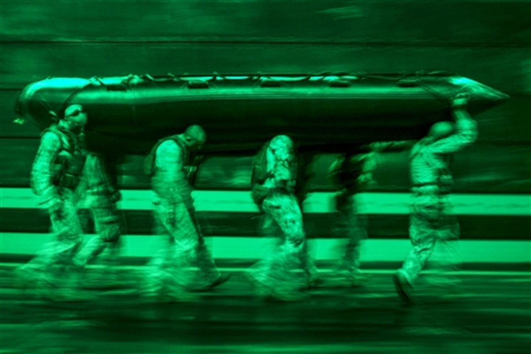 As seen through a night-vision device, U.S. Marines prepare a combat rubber raiding craft for launch-and-recovery drills during Talisman Sabre 2015 from the well deck of the USS Green Bay at sea, July 9, 2015. The Marines are assigned to Fox Company, Battalion Landing Team 2nd Battalion, 5th Marines, 31st Marine Expeditionary Unit.