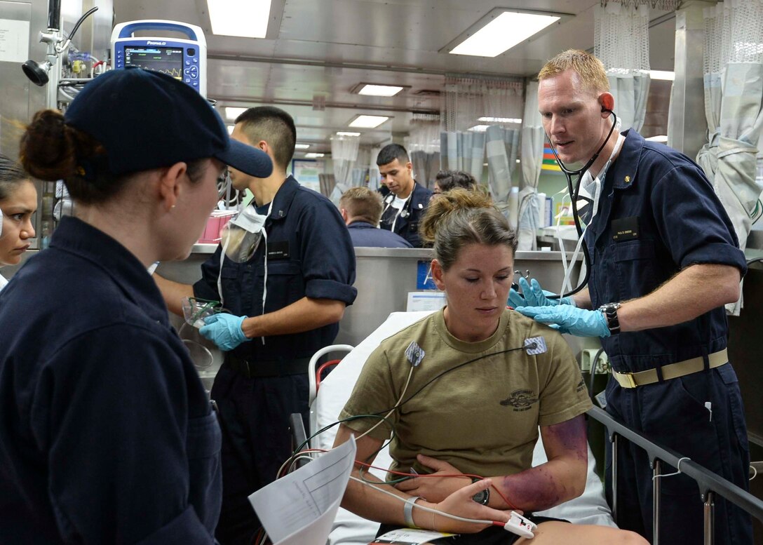 U.S. Navy crew members on board the hospital ship USNS Mercy conduct a mass casualty drill during Pacific Partnership 2015 in the Philippine Sea, July 16, 2015. 