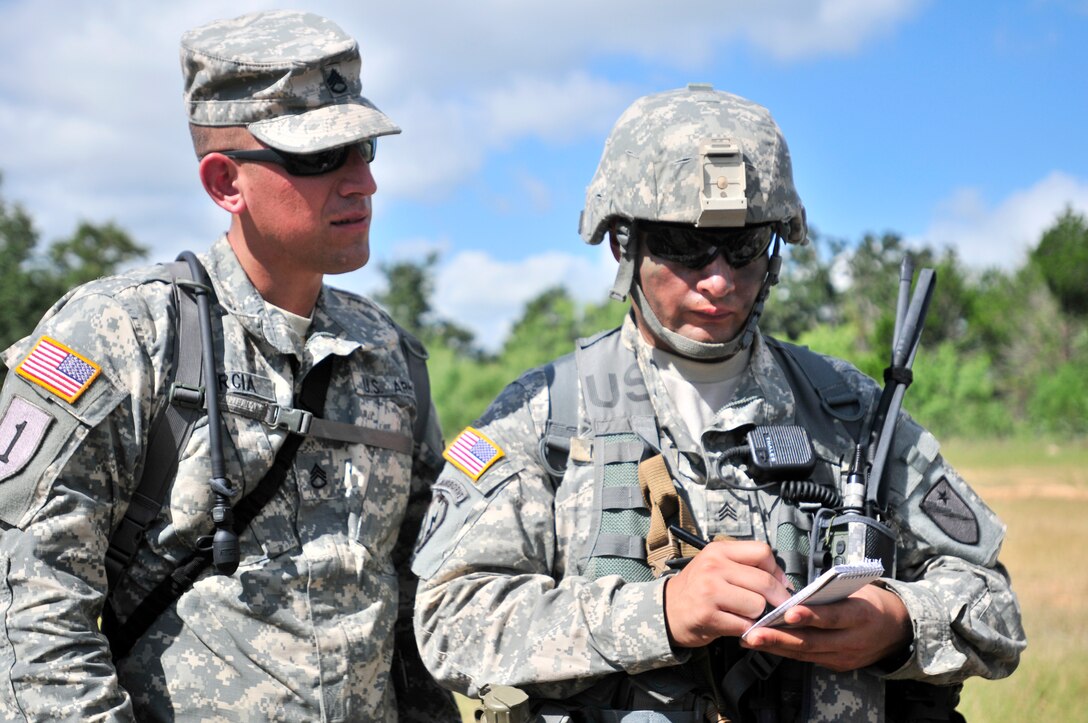 Members of the Texas Army National Guard's 836th Engineer Company discuss mission training on Camp Swift, Texas, July 14, 2015. 