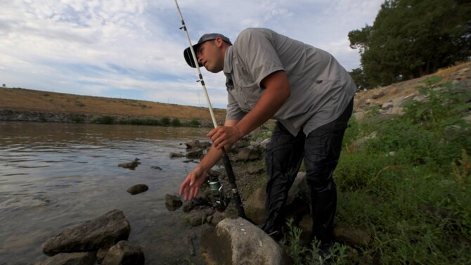 Senior Airman Jaye Legate, 366th Fighter Wing Public Affairs broadcast journalist, sets the drag on his fishing pole July 6, 2015, at Crane Falls, Idaho. Legate was hoping to land a White Sturgeon, one of the more elusive fish in the region. (U.S. Air Force photo by Airman 1st Class Connor J. Marth)