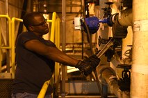 Colby Holloman, 341st Civil Engineer Squadron utilities systems operator, repaires piping on a high-temperature water strainer at the heat plant July 16, 2015, at Malmstrom Air Force Base, Mont. Heat plant operations provides essential heating to 70 infrastructure buildings on base. (U.S. Air Force photo/Chris Willis)